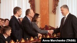 Ukrainian President Petro Poroshenko (right) shakes hands with new judges from Ukraine's High Anti-Corruption Court during an oath-taking ceremony on April 11. 