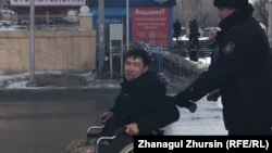 Disabled Kazakh activist Asanali Suyubaev being detained by police in Aqtobe in February