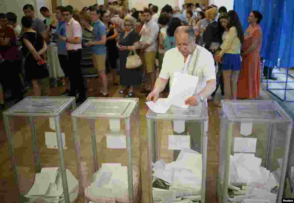 A man casts his vote at a polling station in Kyiv.