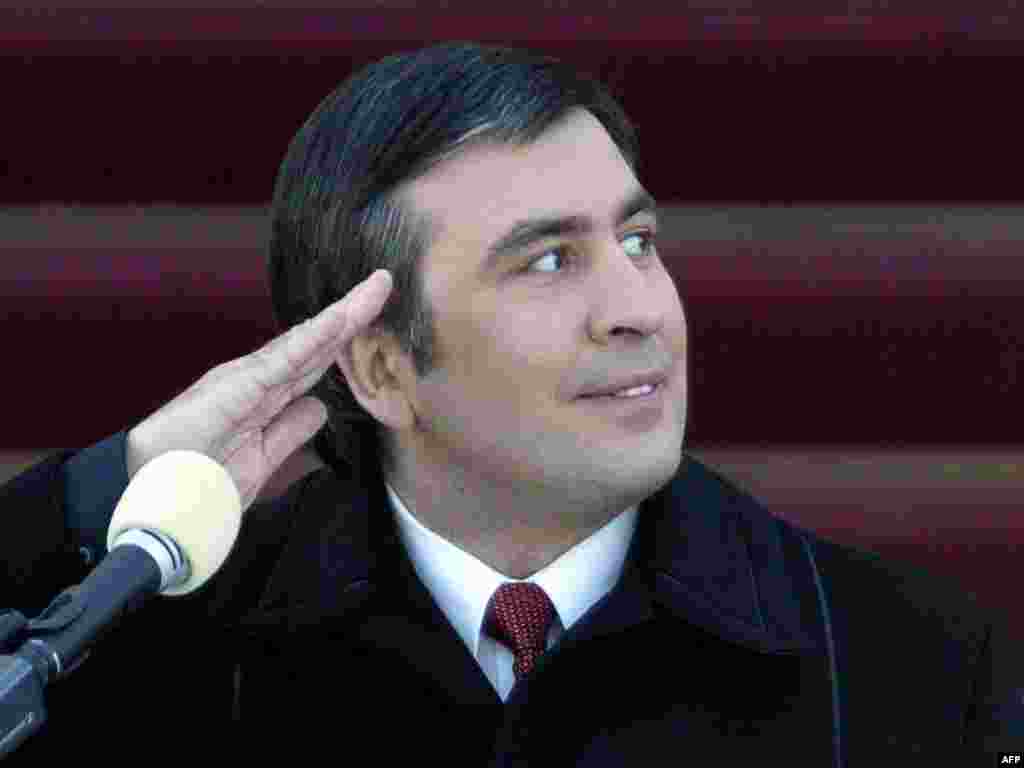 Georgian President Mikheil Saakashvili salutes while he watches a military parade during his inauguration ceremony in Tbilisi on January 25, 2004. Saakashvili, 37, was Europe's youngest head of state when he was sworn in.