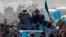 Abdullah Abdullah (in gray) sits atop a vehicle at an election rally in the Panjshir Province on March 31, 2014.