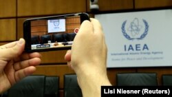 A person uses a smartphone to film the seat of the Director General of the International Atomic Energy Agency (IAEA) ahead of a board of governors meeting at the IAEA headquarters in Vienna, Austria July 25, 2019.