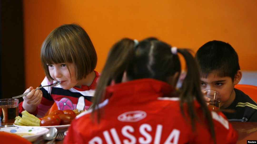 Children eat at an orphanage in the southern Russian city of Rostov-na-Donu. No "puppies" who will grow up to be "good attack dogs" here...