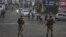 Indian paramilitary soldiers stand guard during curfew-like restrictions in Jammu on August 5.