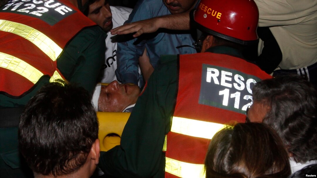 Rescue workers carry injured Pakistani cricketer-turned-politician Imran Khan, who is also chairman of the Pakistan Movement for Justice party, after he fell from a makeshift elevator during his campaign rally in Lahore on May 7.
