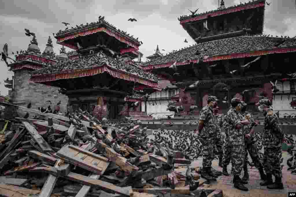 Nepalese soldiers stand next to wrecked buildings in Durbar Square in Kathmandu, a UNESCO World Heritage site that was badly damaged by last week's massive earthquake. (AFP/Philippe Lopez)