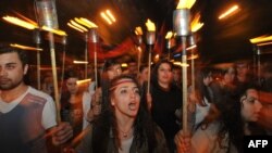 People carry torches to mark the 97th anniversary of the genocide of their kin by Ottoman Turks during World War I in central Yerevan on April 23.