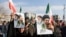 Iran - People hold placards with an image of Iran's new supreme leader, Mojtaba Khamenei, with late Iranian Supreme Leader Ayatollah Ali Khamenei, during a gathering in Tehran, March 9, 2026.