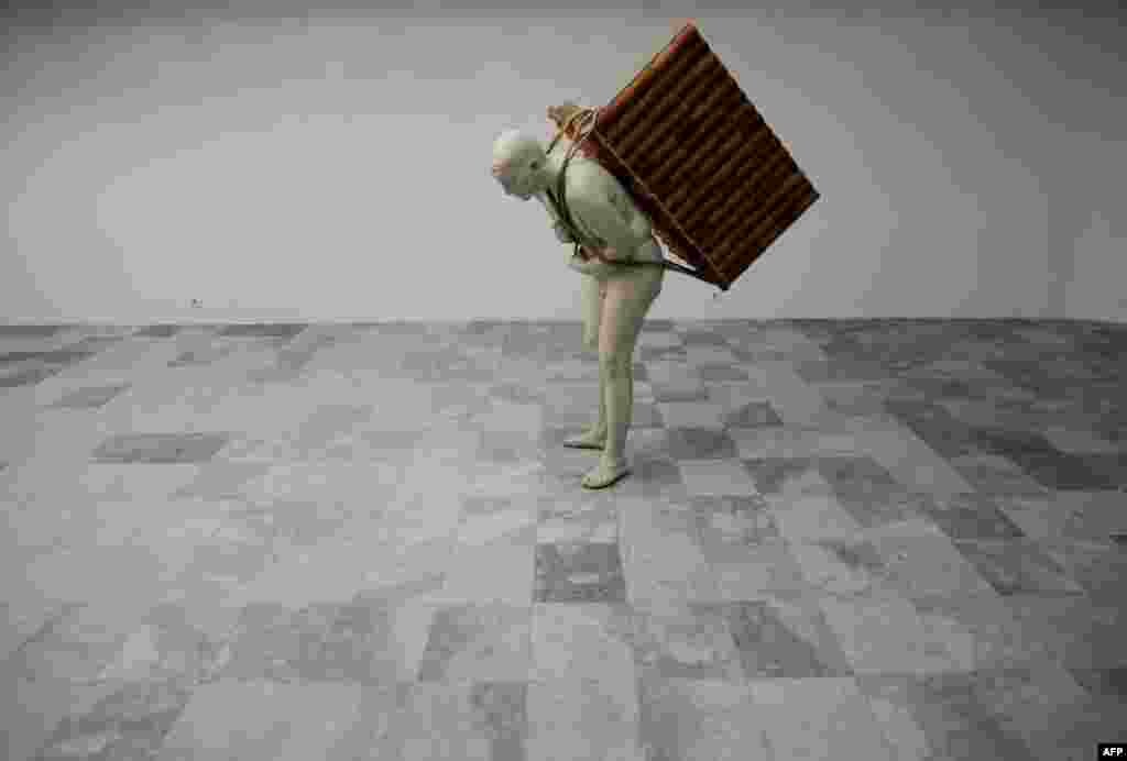 A sculpture titled "Home To Go" by Albanian-born artist Adrian Paci is displayed at the Kosovo National Gallery during an exhibition in Pristina. (AFP/Armend Nimani)