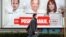 BOSNIA-HERZEGOVINA -- A man walks next to an election campaign poster in Sarajevo, November 10, 2020