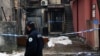 A police officer walks by the crime scene in Cetinje, Montenegro, on January 2, 2025, after a gunman went on a rampage after opening fire at a village restaurant, killing 12 people including two children.