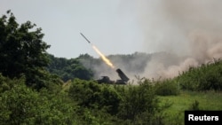 Ukrainian soldiers fire a BM-21 Grad multiple-rocket launch system near the town of Lysychansk in June amid fighting for control of the city.