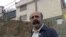 Journalist Keyvan Samimi stands in front of Evin prison