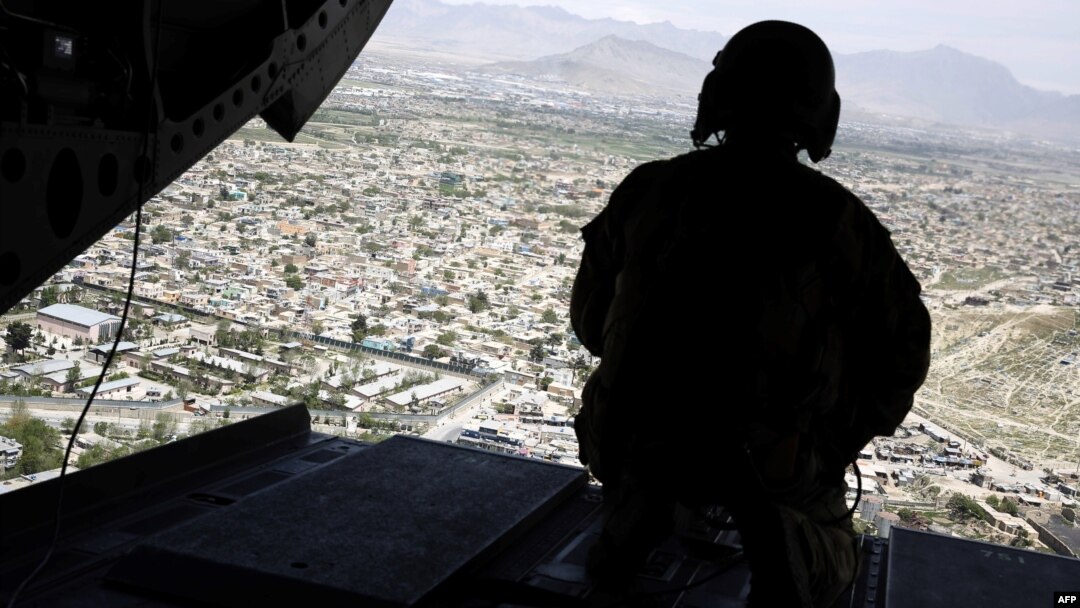 A U.S. soldier mans a weapon aboard a helicopter carrying U.S. Defense Secretary Jim Mattis as he arrived in the Afghan capital, Kabul, in April 2017.