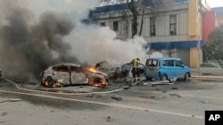 Russian firefighters extinguish fires in blazing cars following what local authorities say was a Ukrainian military strike on the city of Belgorod, in a photograph published on January 5.