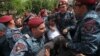 Armenian police officers detain a protester at an anti-government demonstration in Yerevan on May 5,