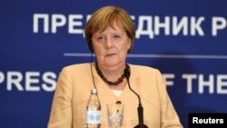 German Chancellor Angela Merkel speaks during a news conference in Belgrade, Serbia. 