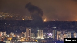 Smoke billows over Beirut's southern suburbs after an Israeli strike on October 7. 