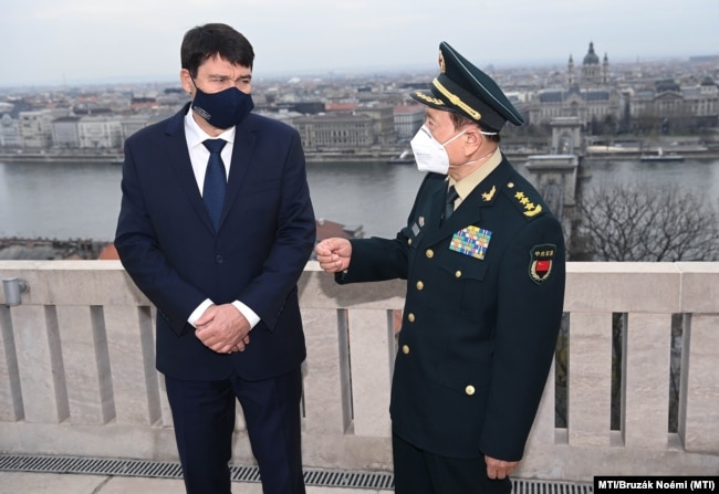 Hungarian President Janos Ader (left) hosts Chinese Defense Minister Wei Fenghe at the Sandor Palace in Budapest on March 24.