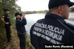 Bosnian border police along the Drina River in Zvornik, Bosnia
