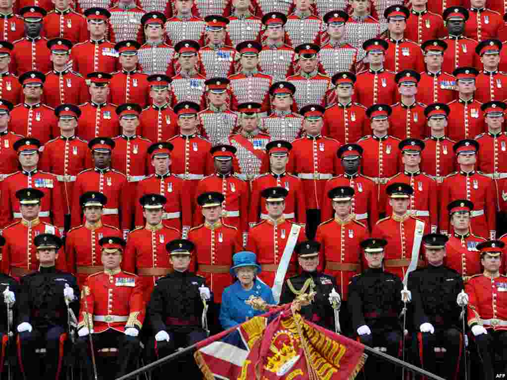 Elizabeth and Philip (front row, center) pose for an official photograph with the Grenadier Guards after presenting the regiment with their new colors in 2010.