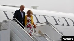 U.S. Vice President Joe Biden (left) and his wife Jill disembark from an aircraft upon their arrival at the airport in New Delhi on July 22. 