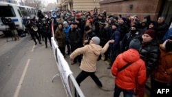 A Russian protester throws a stone towards the Turkish embassy in Moscow on November 25. The recent downing of a Russian warplane by a Turkish jet has caused widespread anger in the country.