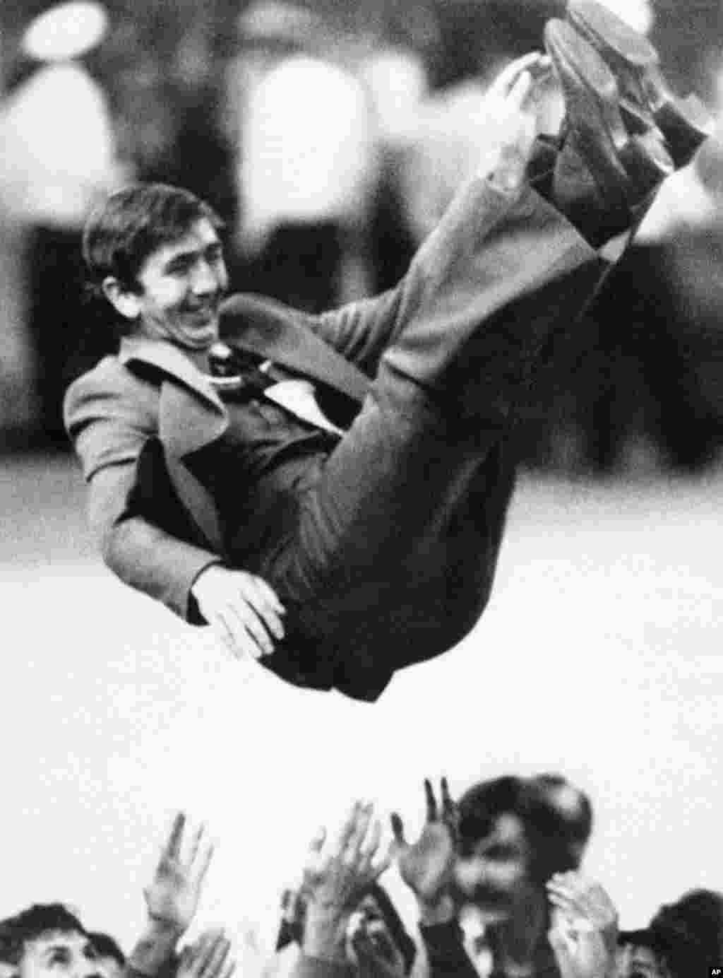 An unidentified Soviet volleyball coach is tossed into the air after his team beat Bulgaria to win gold. &nbsp;