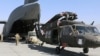 Aerial porters work with maintainers to load a UH-60L Blackhawk helicopter into a C-17 Globemaster III at Bagram Airfield on June 16.