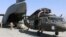 Aerial porters work with maintainers to load a UH-60L Blackhawk helicopter into a C-17 Globemaster III at Bagram Airfield on June 16.
