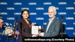 Сьвятлана Ціханоўская ўручае Алесю Бяляцкаму Крыж Свабоды