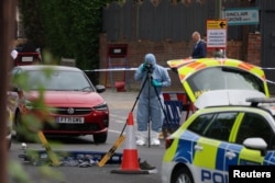 A forensics official works at the scene of a stabbing incident in the Golders Green area, which is home to a large Jewish population, in London on April 29.