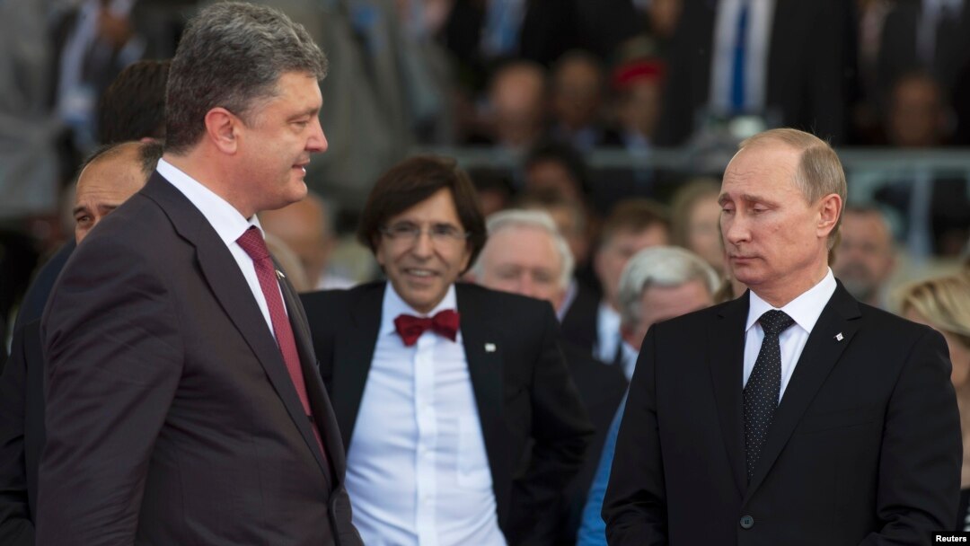 Ukrainian President-elect Petro Proshenko (left) walks past Russian President Vladimir Putin (right) during the commemoration ceremony for the 70th anniversary of D-Day at Sword beach in Ouistreham, France on June 6, before Poroshenko had been sworn in as president.
