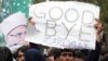 A supporter of Muhammad Tahir-ul-Qadri holds up an antigovernment sign during a fourth day of protests in Islamabad on January 17.