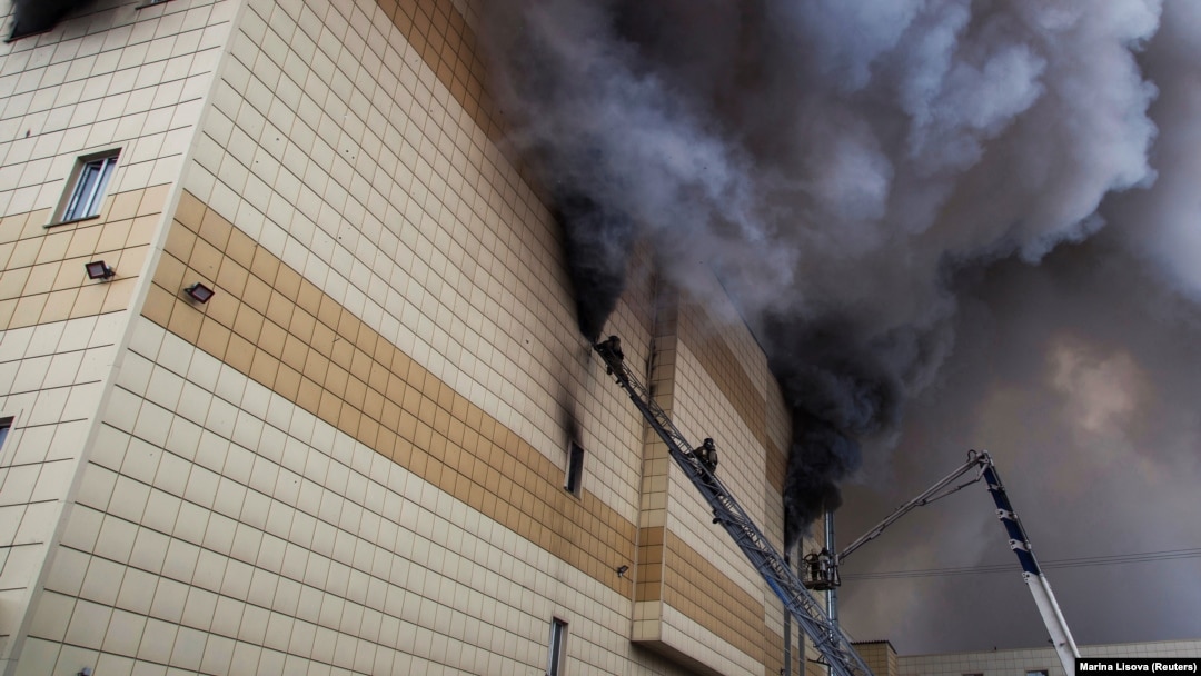 Firefighters work to extinguish the fire that engulfed the Zimnyaya Vishnya shopping mall in Kemerovo, killing 60 people, in March 2018.