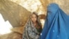 Soraya (right) sits with her younger sister inside a tent at a makeshift camp for internally displaced persons (IDPs) in the northern province of Balkh.