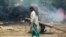 An Indian man walks near a residential area that was gutted from firing allegedly from the Pakistan side of the border in Jora farm village, in Ranbir Singh Pura district of Jammu and Kashmir in May.