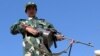 An Afghan National Army soldier stands guard at the Pakistan-Afghanistan border