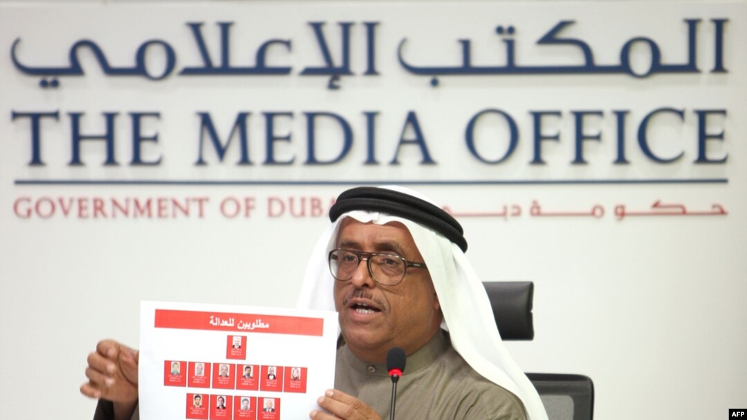 Dubai police chief Dhafi Khalfan holds up identity pictures of 11 suspects in the Hamas commander's killing during a press conference in Dubai on February 15.