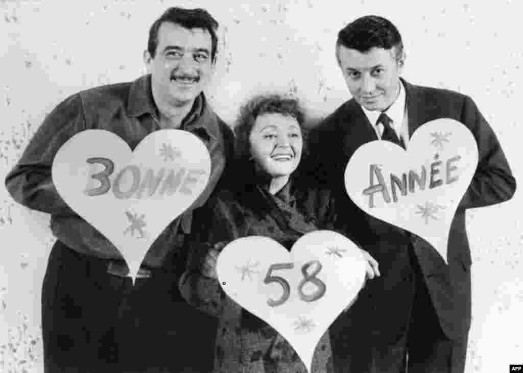 Piaf posing with stage partners Armand Mestral and Michel Auclair on December 30, 1957 in Paris wishing a Happy New Year to the audience.