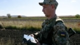 A Ukrainian guard uses a drone to search the border for illegal crossings