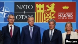 NATO Secretary General Jens Stoltenberg (left), Turkish President Recep Tayyip Erdogan (second left), Finnish President Sauli Niinisto (second right), and Swedish Prime Minister Magdalena Andersson pose after signing a joint memorandum during the NATO summit in Madrid on June 28. 