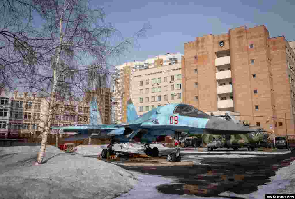 A SU-34 military jet is seen in a yard amid apartment blocks in Moscow on March 15. (AFP/Yuri Kadobnov)