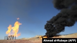 Gas flares at the Havana oil field, west of the northern Iraqi city of Kirkuk