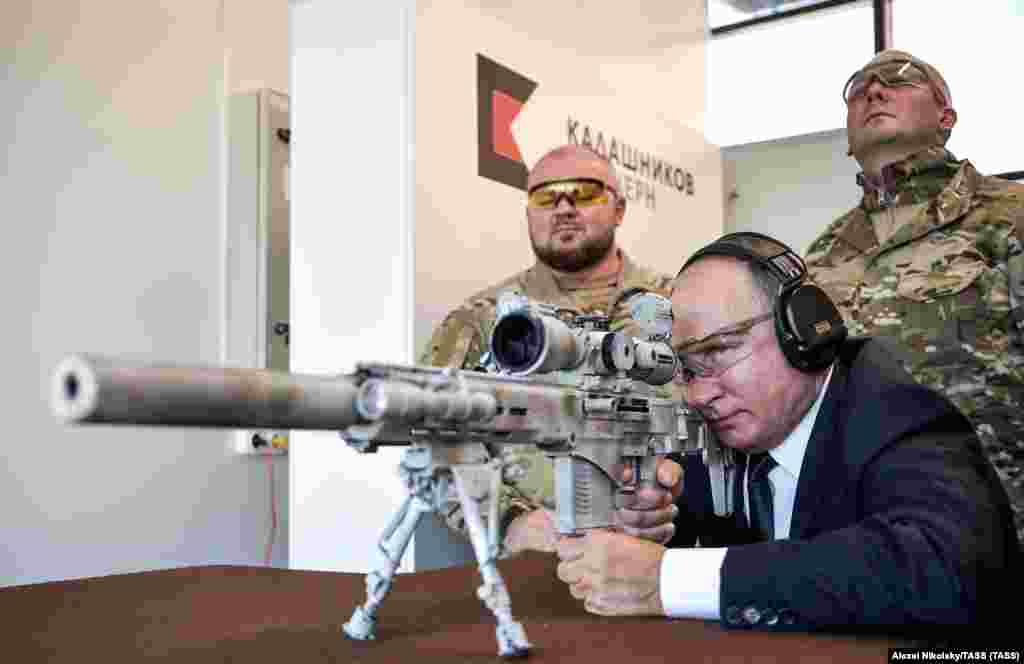 Russian President Vladimir Putin aims a sniper rifle at the Kalashnikov shooting range in Moscow in September 2019.