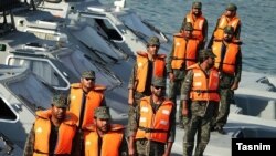 IRGC's Navy forces posing on their Fast attack craft, during President Rouhani's visit of IRGCN 1st Naval District Command center, on February 27, 2014.