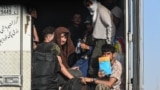 Afghan refugees arrive in the Islam Qala border crossing between Afghanistan and Iran on June 27, 2025, following their deportation from Iran.