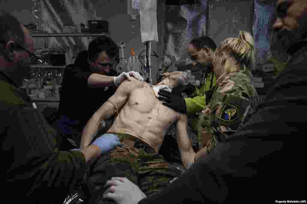 Ukrainian military medics are seen treating a wounded soldier at a field hospital near Bakhmut in Ukraine&#39;s Donetsk region on February 26. Russian forces have been relentlessly attacking the city since last summer.&nbsp;Moscow redoubled its efforts to take the city at the start of this year, launching a fresh offensive.