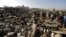 People gather at the site of an air strike in a residential area near Sanaa airport on March 26.