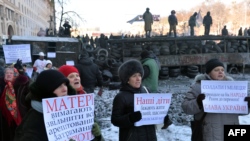 Женщины с плакатами, призывающими милицию прекратить насилие и перейти на сторону протестующих (Киев, 24 января 2014 года)